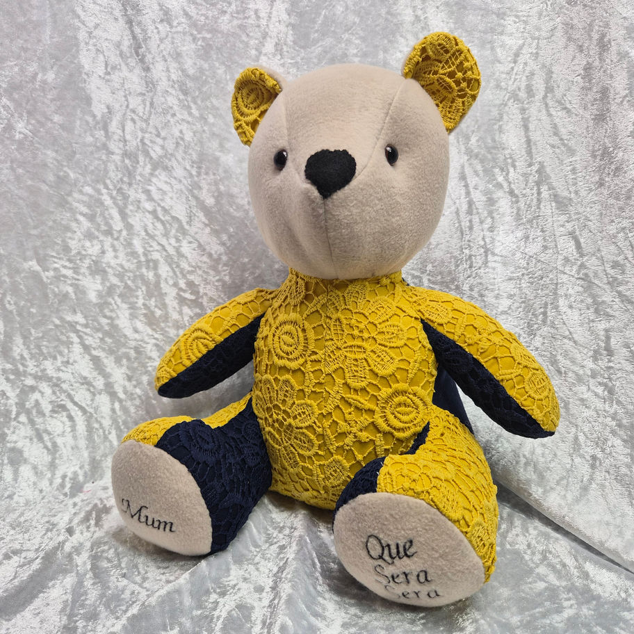 Handmade standard memory bear keepsake made from clothing featuring yellow lace fabric and personalised embroidery.