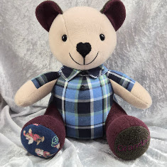 Handmade memory bear created from a loved one's clothing in blue tartan shirt fabric with burgundy fleece contrast paws and novelty fabric paw detailHandmade memory bear created from a loved one's clothing in blue tartan shirt fabric with burgundy fleece contrast paws and novelty fabric paw detail