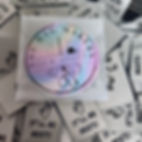 “The Bag Makers Sew-Ciety” sticker placed on top of a pile of “It’ll Be Reet” woven labels.