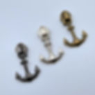 Three metal zipper pulls with heart cut-outs at the bottom, displayed in gunmetal, silver, and antique brass finishes