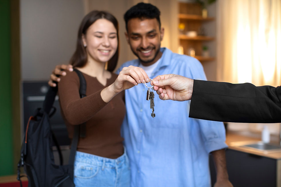 Smiling couple receiving keys to their new home.