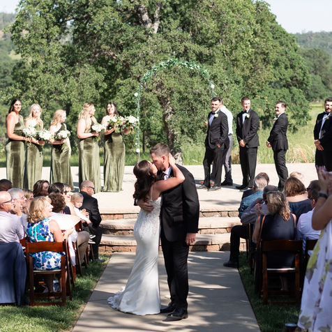 Wedding couple kissing at the ceremony at River Highlands Ranch in Smartsville, CA.