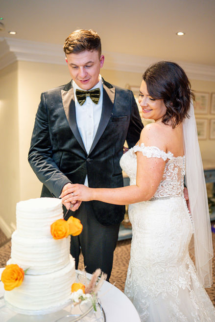 Bride and groom cut wedding cake. Wedding ceremony, joyful moment, Mo Photography