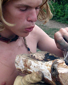 boy making a bowl using fire
