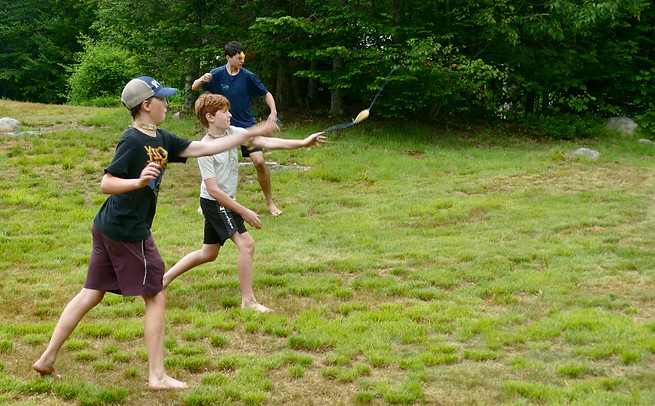Boys throwing slingshots
