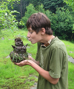 Boy holdin a clay snow woman