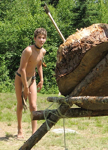 A boy throwing tomahawks at a taget