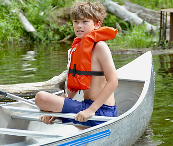 A camper in the bow of a canoe