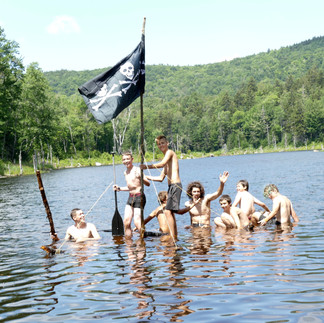 Boys playing pirate on a sunken raft
