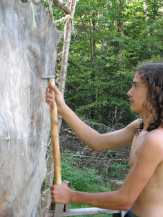 Boys scraping a moose hide at Night Eagle
