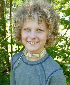 A happy boy wearing his homemade choker
