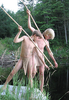 Survival skills - Two campers in breechclouts using hand made fishing spears at a Vermont lake