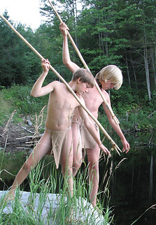 Survival skills - Two campers in breechclouts using hand made fishing spears at a Vermont lake