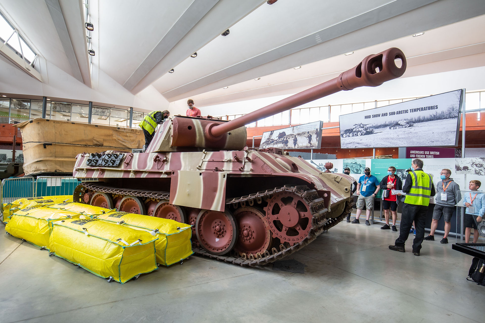 AirDeck alongside a tank with visitors surrounding the tank and a staff member and visitor on top.