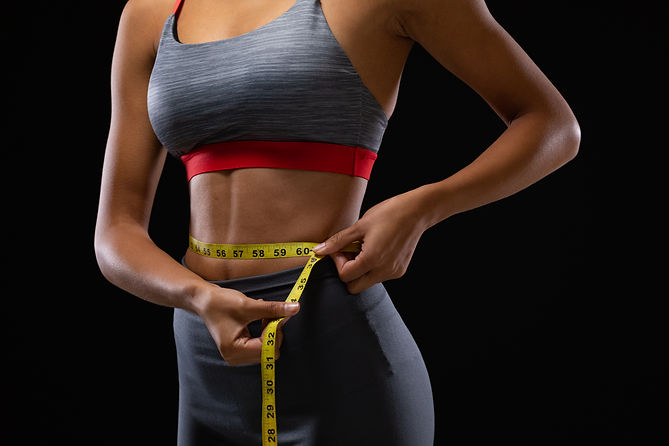 fit-mixed-race-woman-measuring-her-waist-with-meas-2025-04-04-07-55-26-utc.jpg
