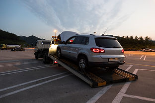 grey suv being pulled onto a car.jpeg