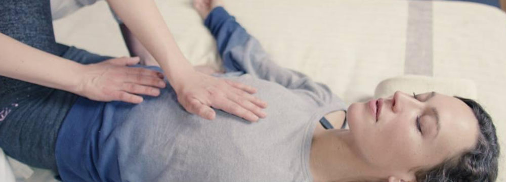 I put my hands of the chest and belly of a female client for relaxation and exchanging good energy