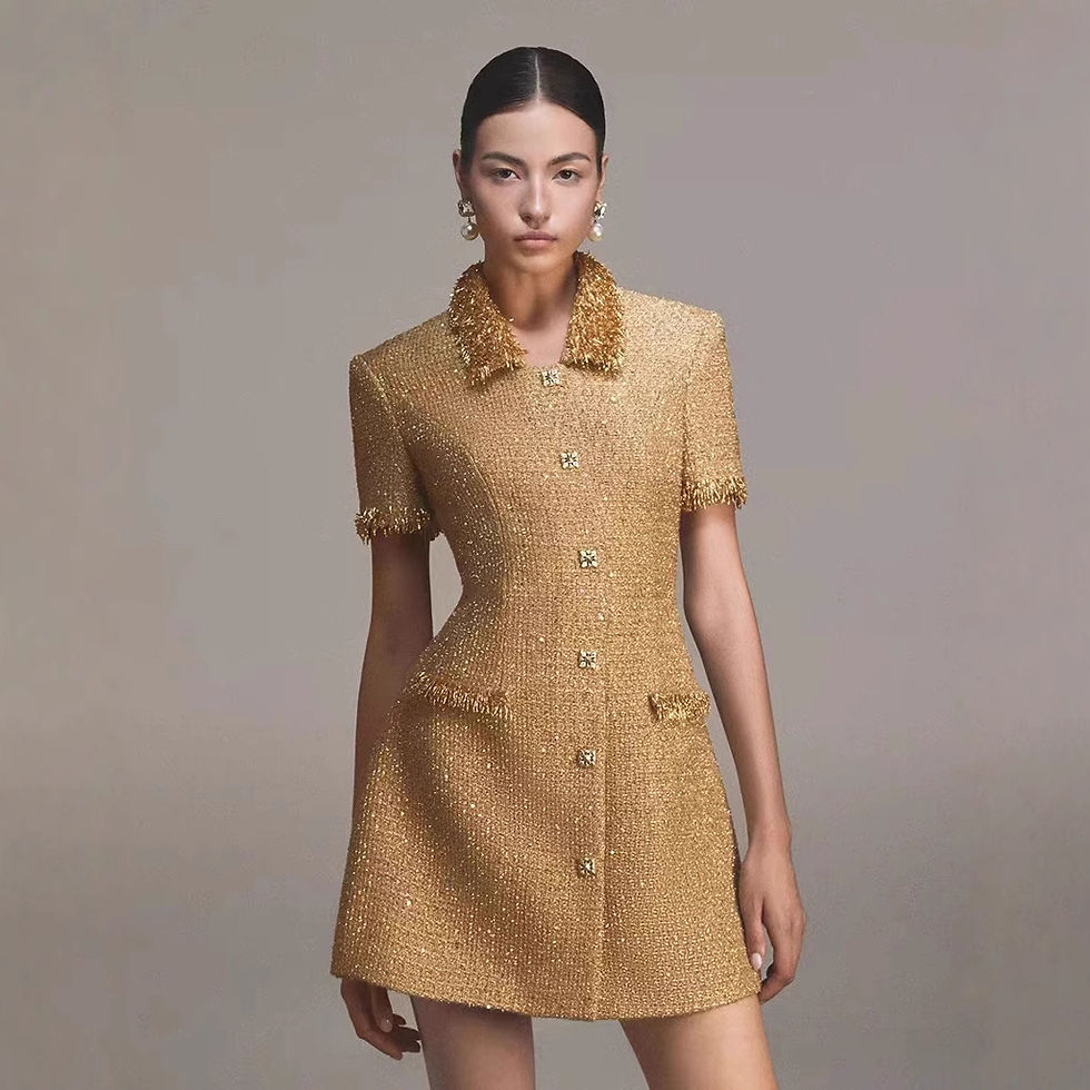 Model wearing golden tweed mini dress with embellished collar
