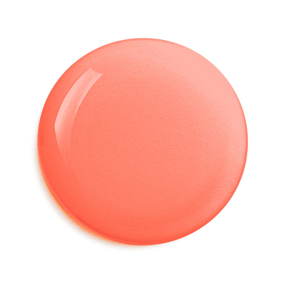 Coral-colored skincare product, close-up. Rosehip & Lemongrass Lip Balm SPF 15 provides moisture.