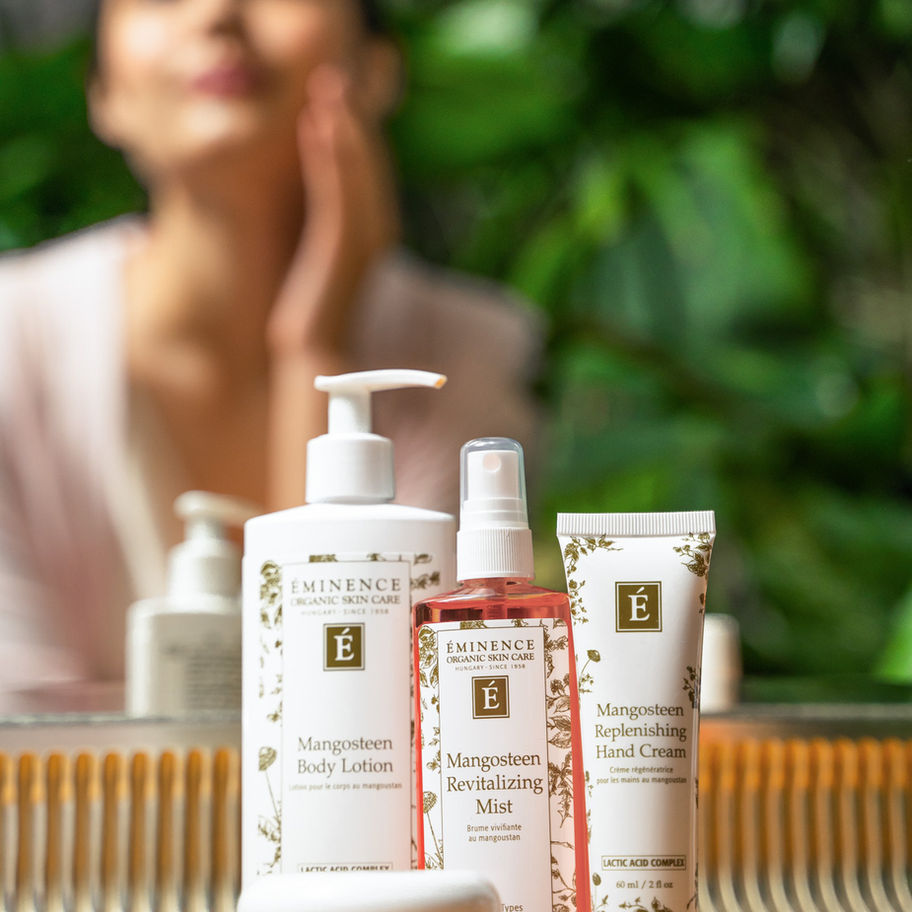 Woman using products with visible text of Rosehip & Lemongrass Lip Balm SPF 15.