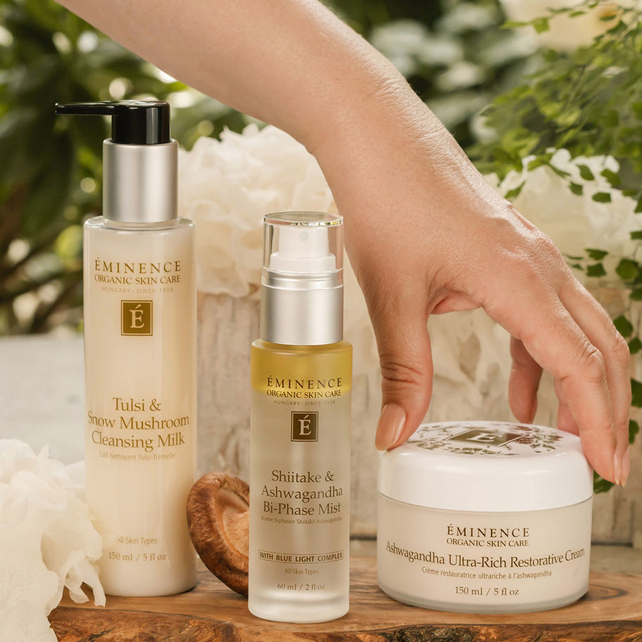 Hand touching skincare products; Eminence Organic Skin Care with Honey Moisture Cleansing