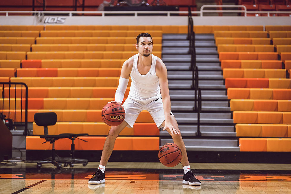 This image is myself (Thomas Dziagwa) doing 2 ball dribbling to warm up for a big12 basketball game.