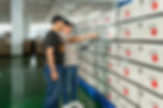 Two men inspecting products in a factory warehouse