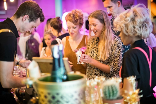 Women receiving drinks at a bar