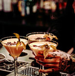 Warm colours and a bartender serving delicious cocktails