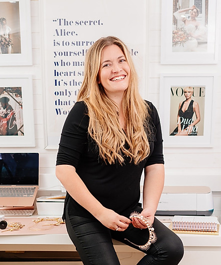 gemma victoria sat on a desk holding a bridal crown