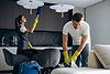 man-from-cleaning-service-housekeeper-vacuuming-sofa (2).jpg