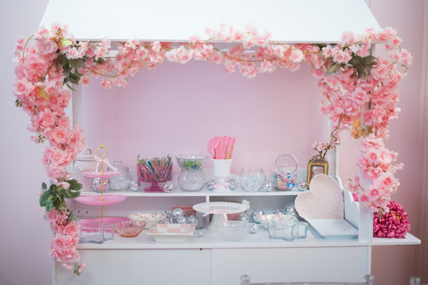 The Dainty Den candy cart candy bar with flowers and candy dishes