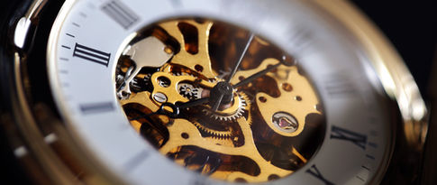 Horloger jurassien travaillant une montre mécanique dans un atelier en bois