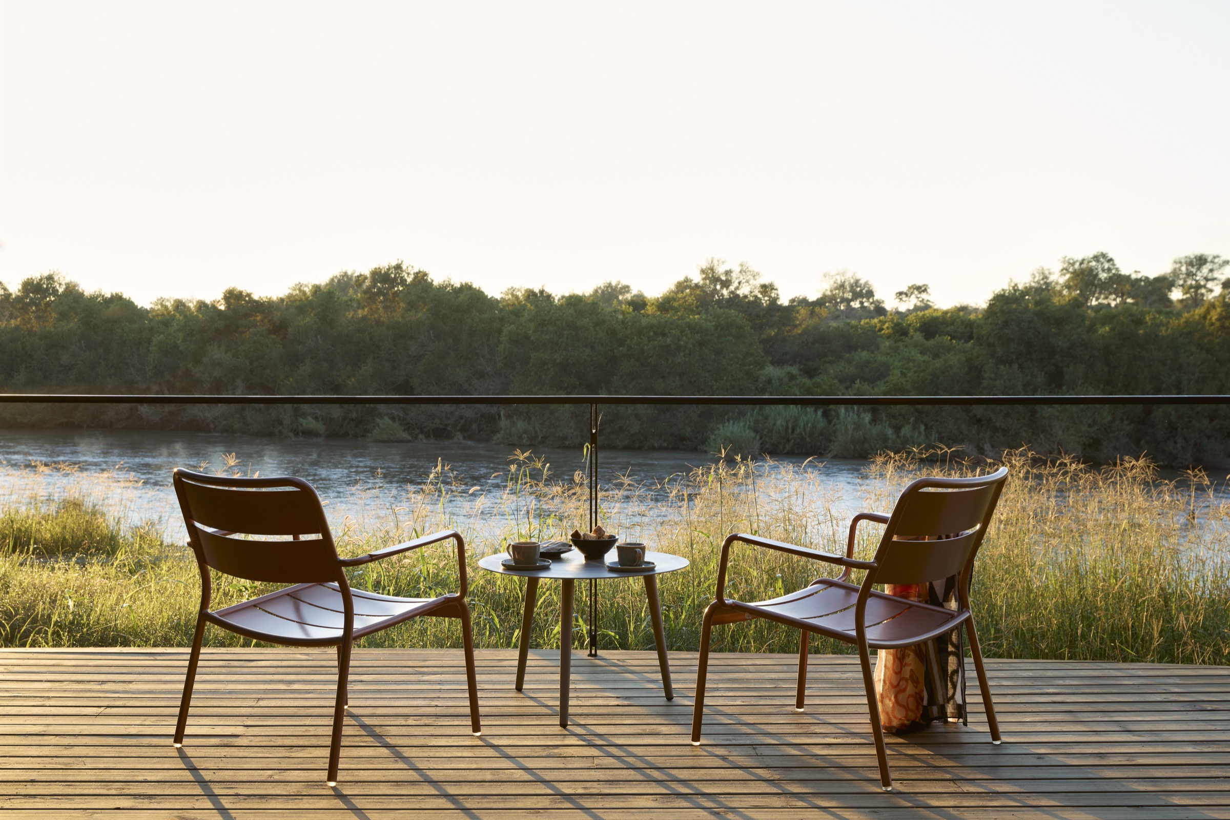Two chairs overlooking the Sabie River from the deck at Lion Sands River Lodge