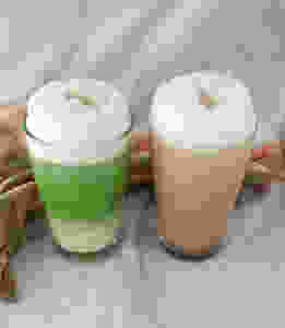 vegan matcha latte or cacao latte using almond milk to froth
