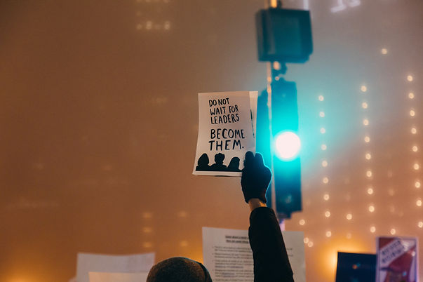someone holding up a sign that says Do Not Wait for Leaders, Become Them.jpe