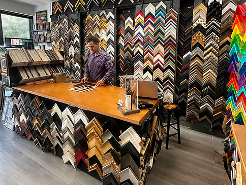 Frame It Plus Coral Springs showroom with frame moulding samples and design counter