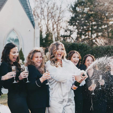 Bride and bridal party together after professional hair and makeup by Team Beauty on wedding day.
