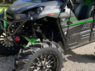 Close-up view of a UTV shock absorber mounted on a suspension arm