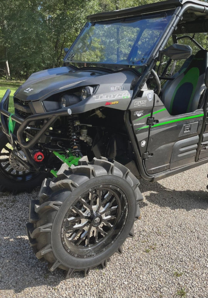 Customer-owned Kawasaki Teryx featuring larger mud tires, aftermarket wheels, windshield, and upgraded suspension components that increase the demands on the factory suspension system.