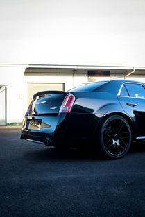 Driver’s side rear angle of Chrysler showing deep, glossy black finish after exterior wash, decontamination, and paint correction by Samurai Auto Detailing in Cairns.