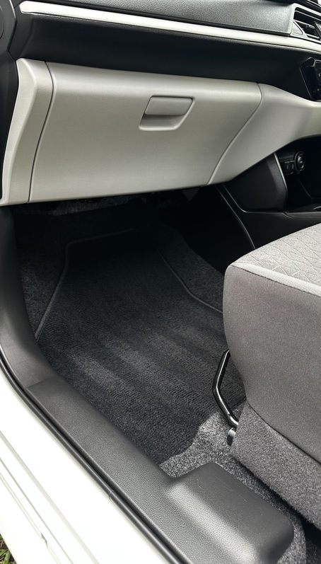 The passenger footwell and glovebox area are spotless after the car detailing service in Cairns.