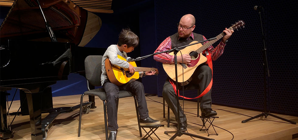 Eye-level view of a cozy music room with a piano and guitar in Brooklyn Heights