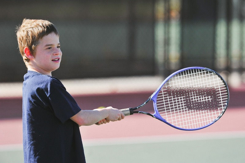Boy playing tennis