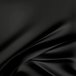 black-satin-fabric-falling-onto-flat-sur