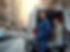 Professional-electrician-standing-beside-fully-stocked-van-in-urban-setting-with-bright-da