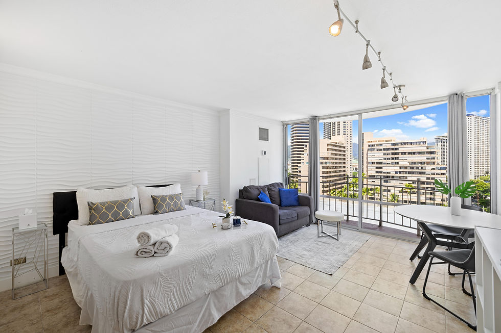 Bright studio with a queen bed, cozy sofa, and private balcony offering city views