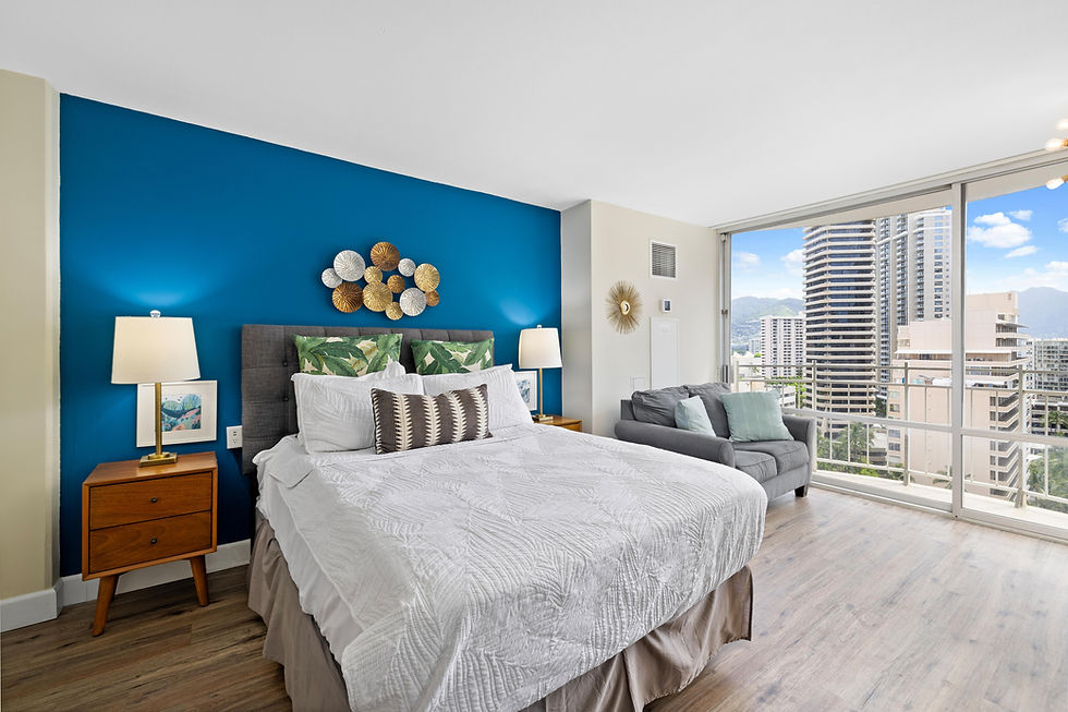 Bright studio with a queen bed, cozy sofa, and private balcony offering city views