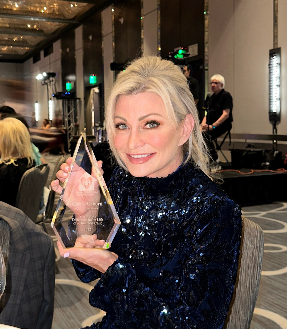 Cheryl Osborn holding philanthropy award