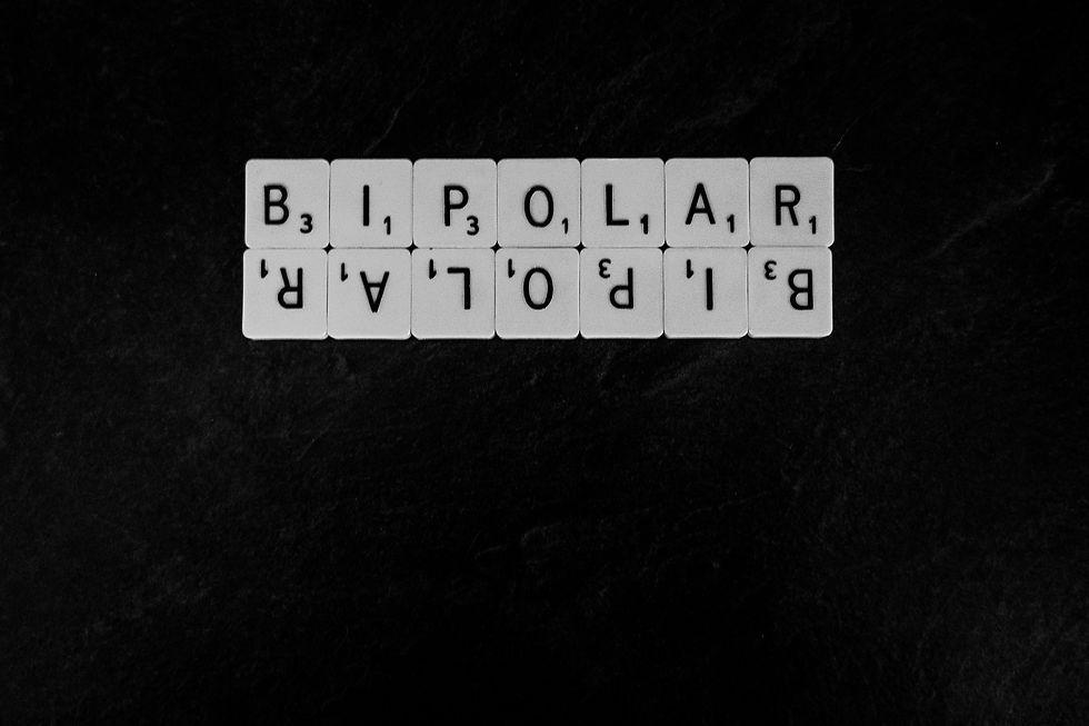 The word Bipolar made from scrabble pieces mirrored on a black background